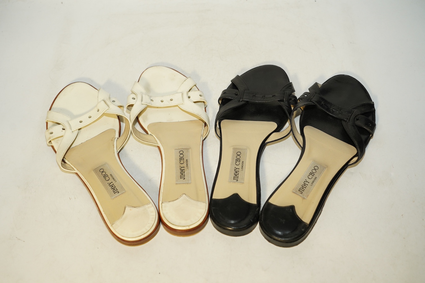 Two pairs of Jimmy Choo flat sandals, black leather and white patent leather, size 41